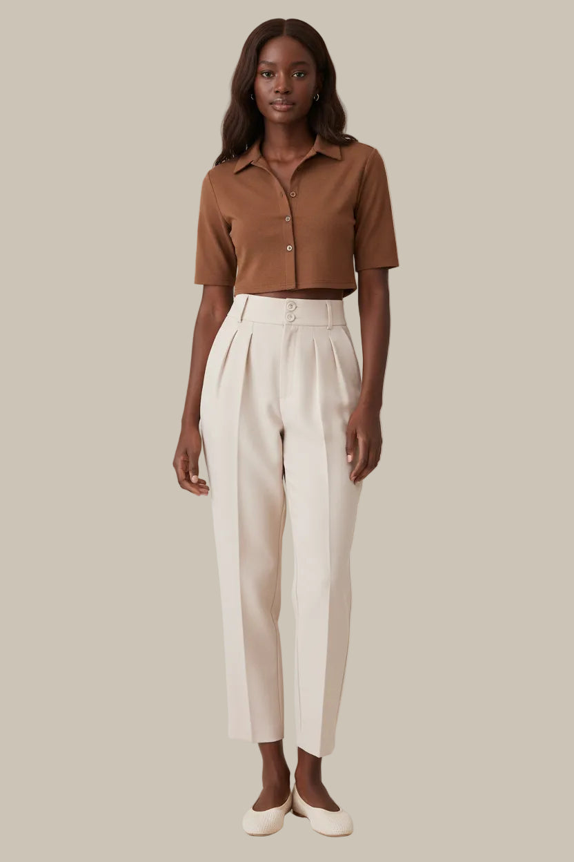 Light pink pants worn by a person on a white background