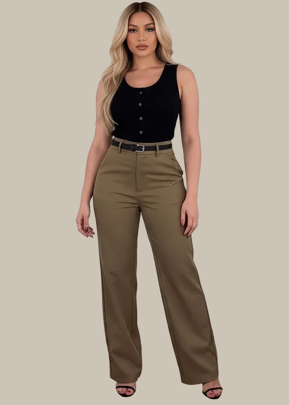 Person wearing brown pants with a black handbag on a wooden floor.