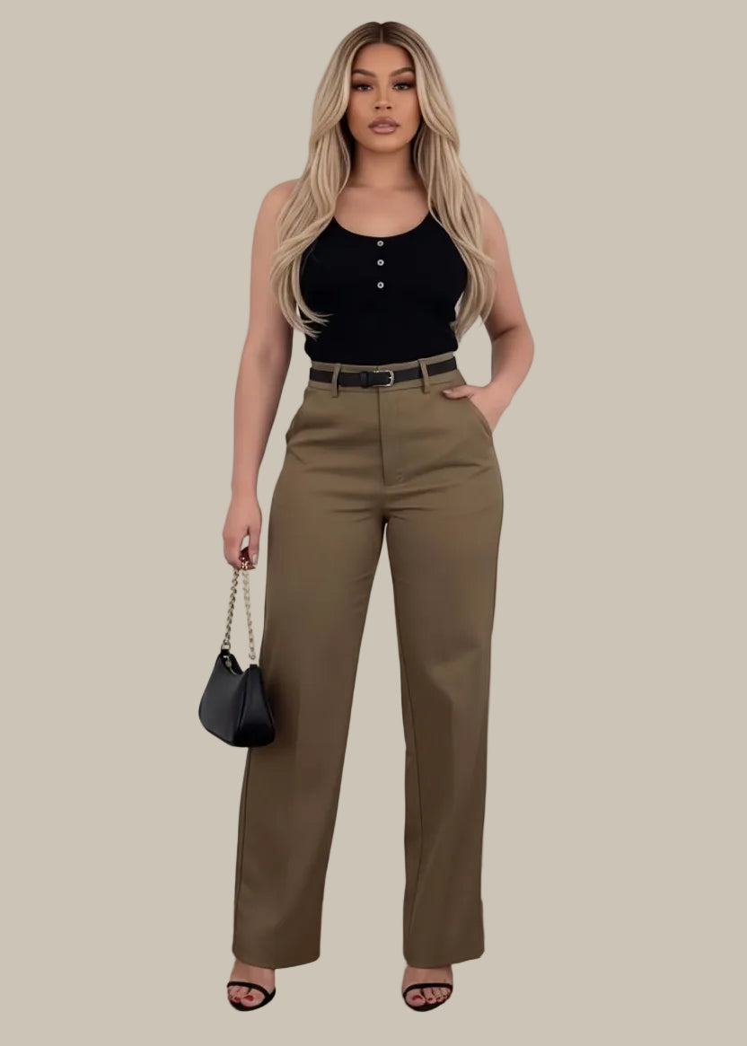 Person wearing brown pants with a black handbag on a wooden floor.