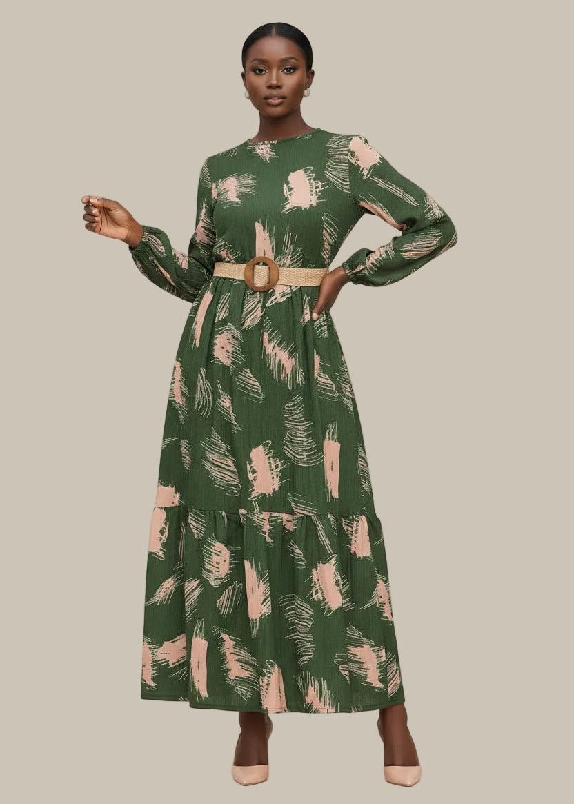 Woman wearing a green dress with a pattern, standing outdoors.