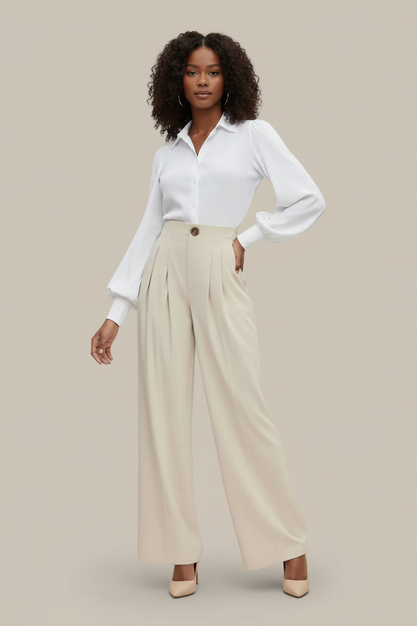 Woman wearing a white shirt and beige pants on a plain background