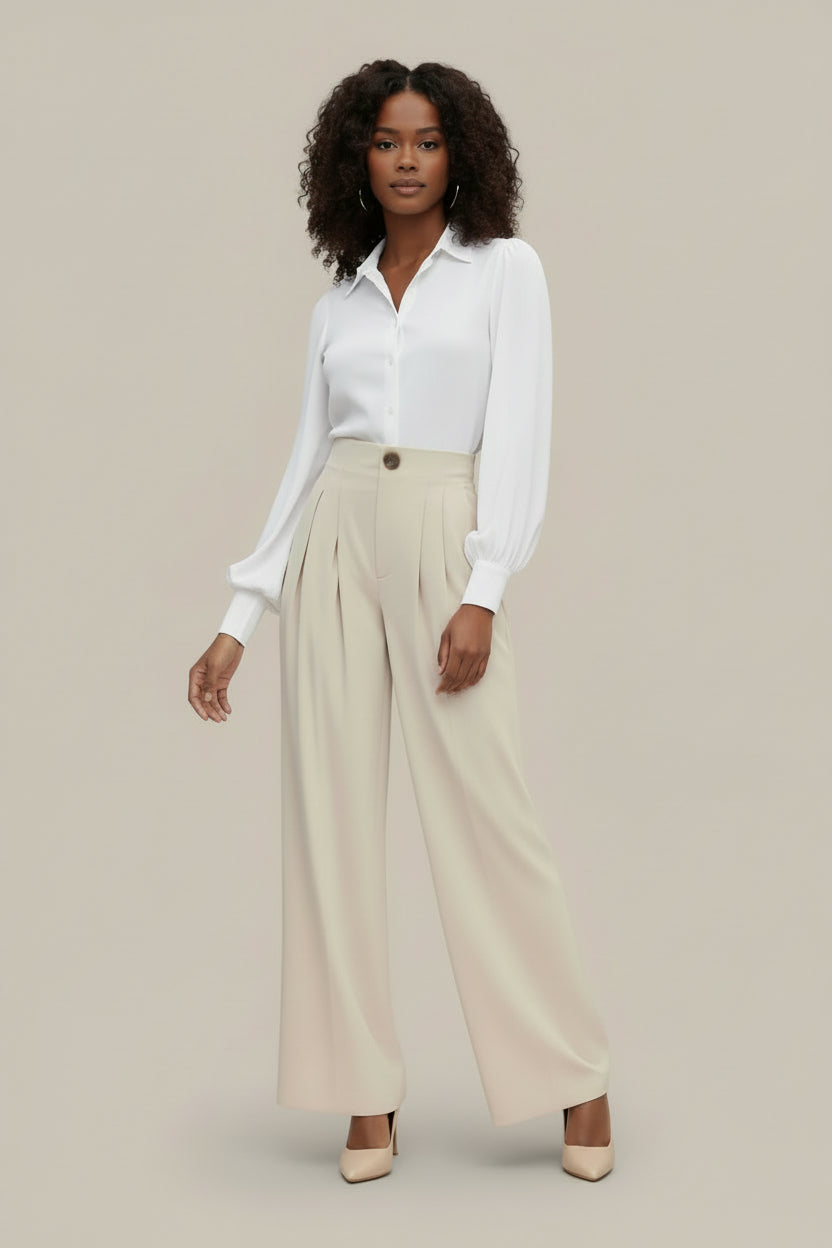 Woman wearing a white shirt and beige pants on a beige background