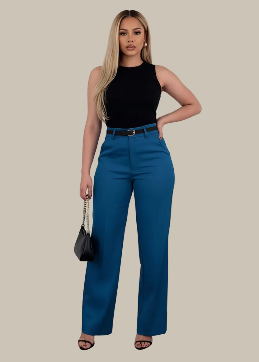 Person wearing blue pants with a black handbag on a white background