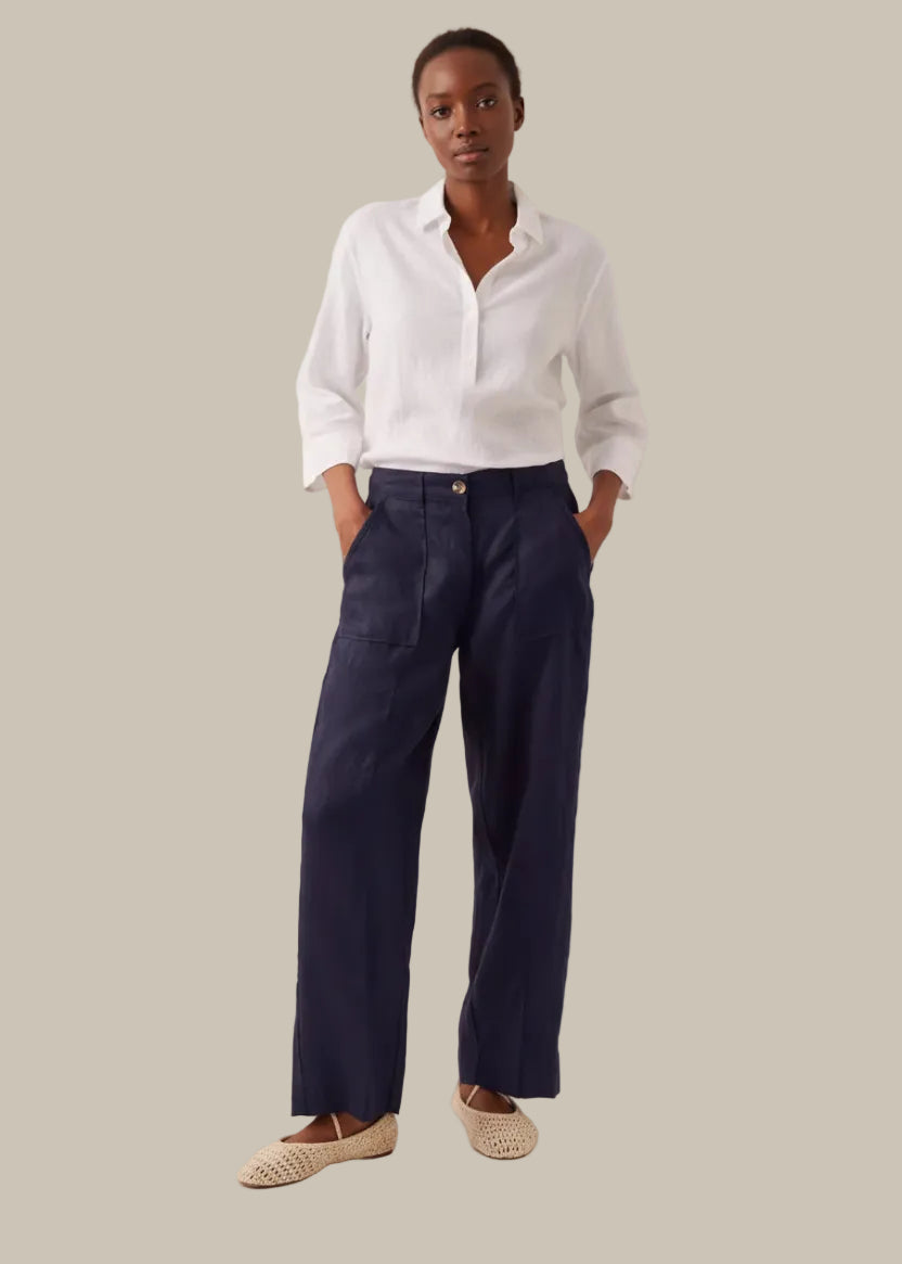 Navy pants worn by a person on a plain background