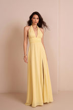 Woman wearing a yellow halter neck gown against a beige background