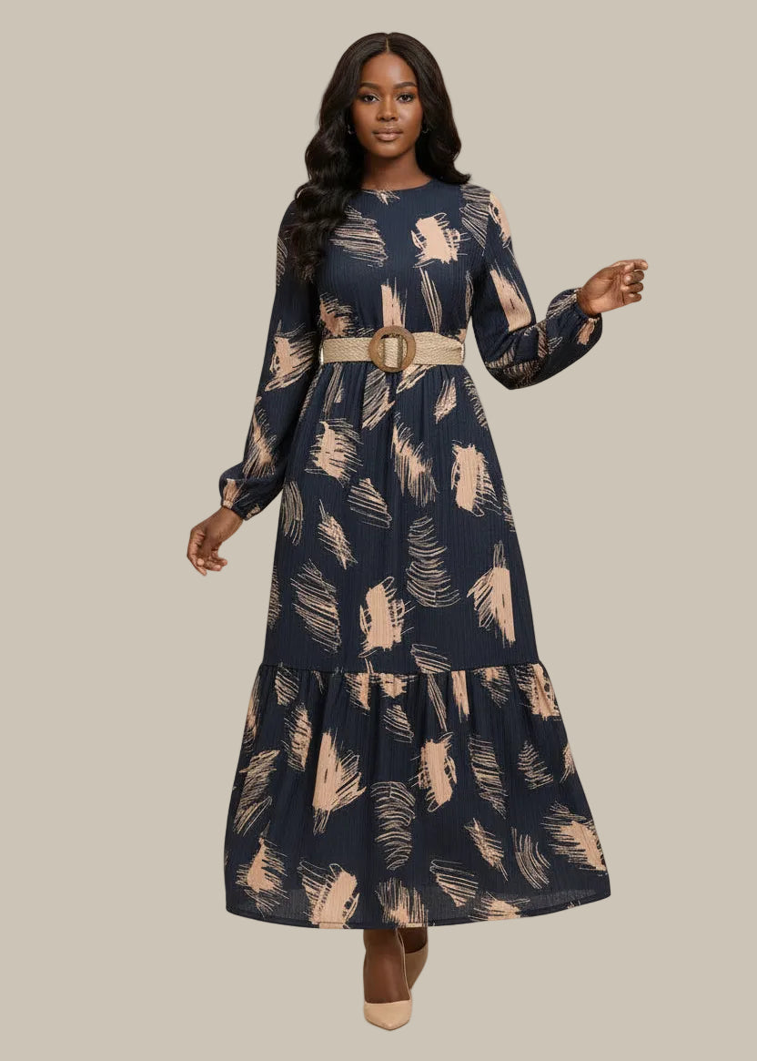 Woman wearing a navy dress with beige abstract patterns on a beige background